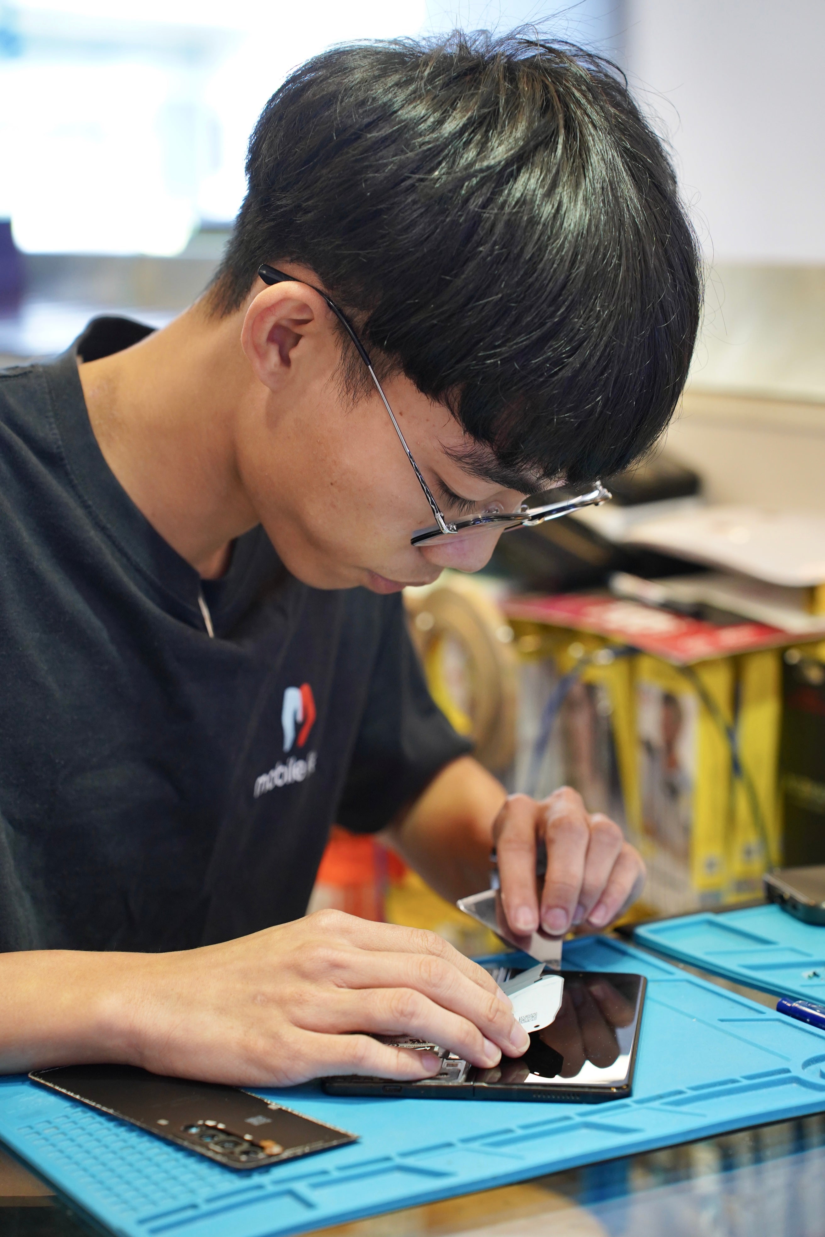 Technician working on mobile repair at Mobile Life